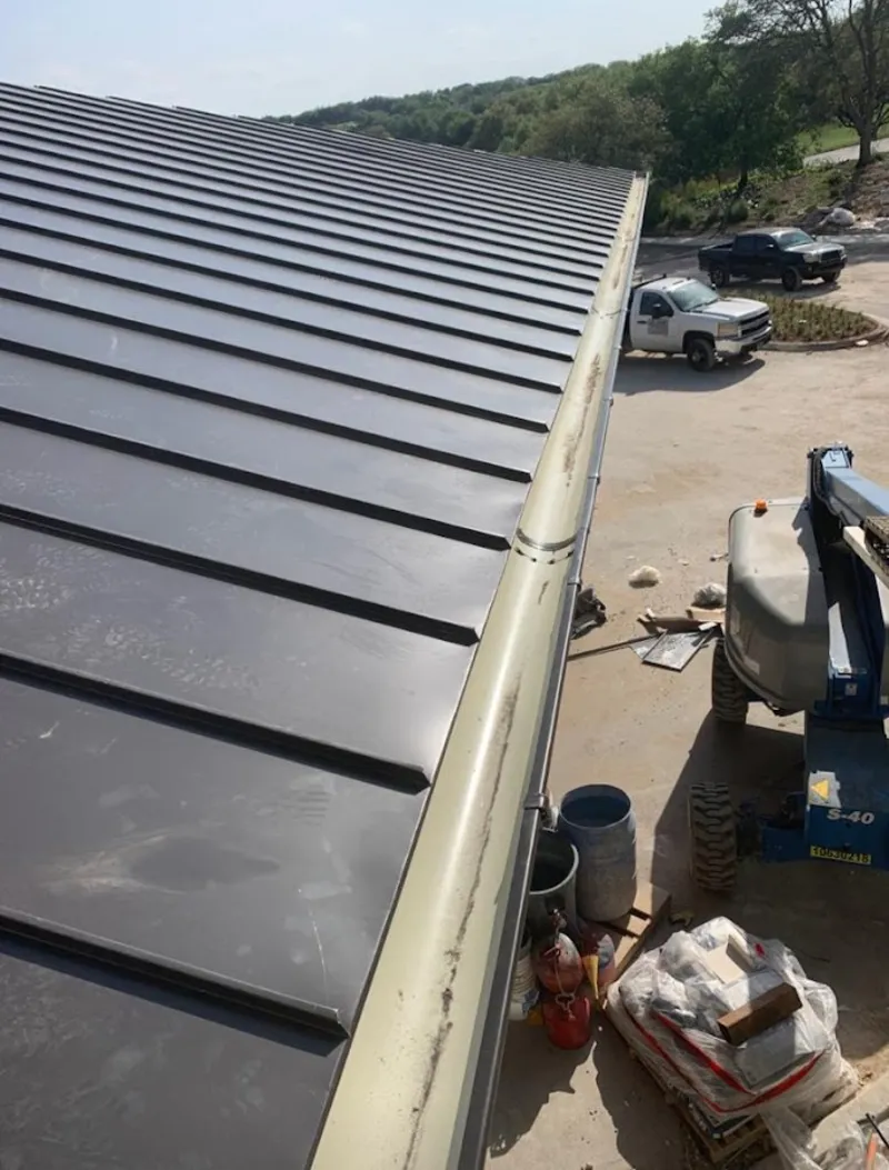 Standing seam panel and gutter detail on a metal roofing jobsite in Berlin